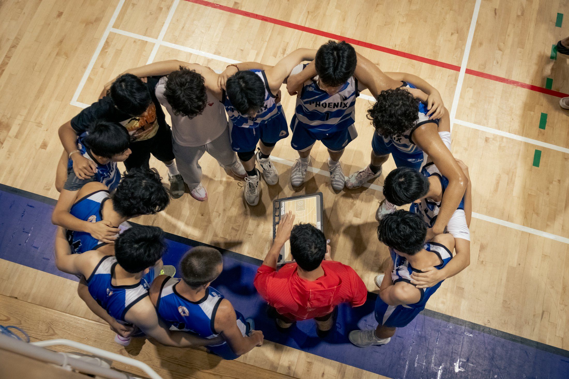 A team huddled together around the plan, seen from above