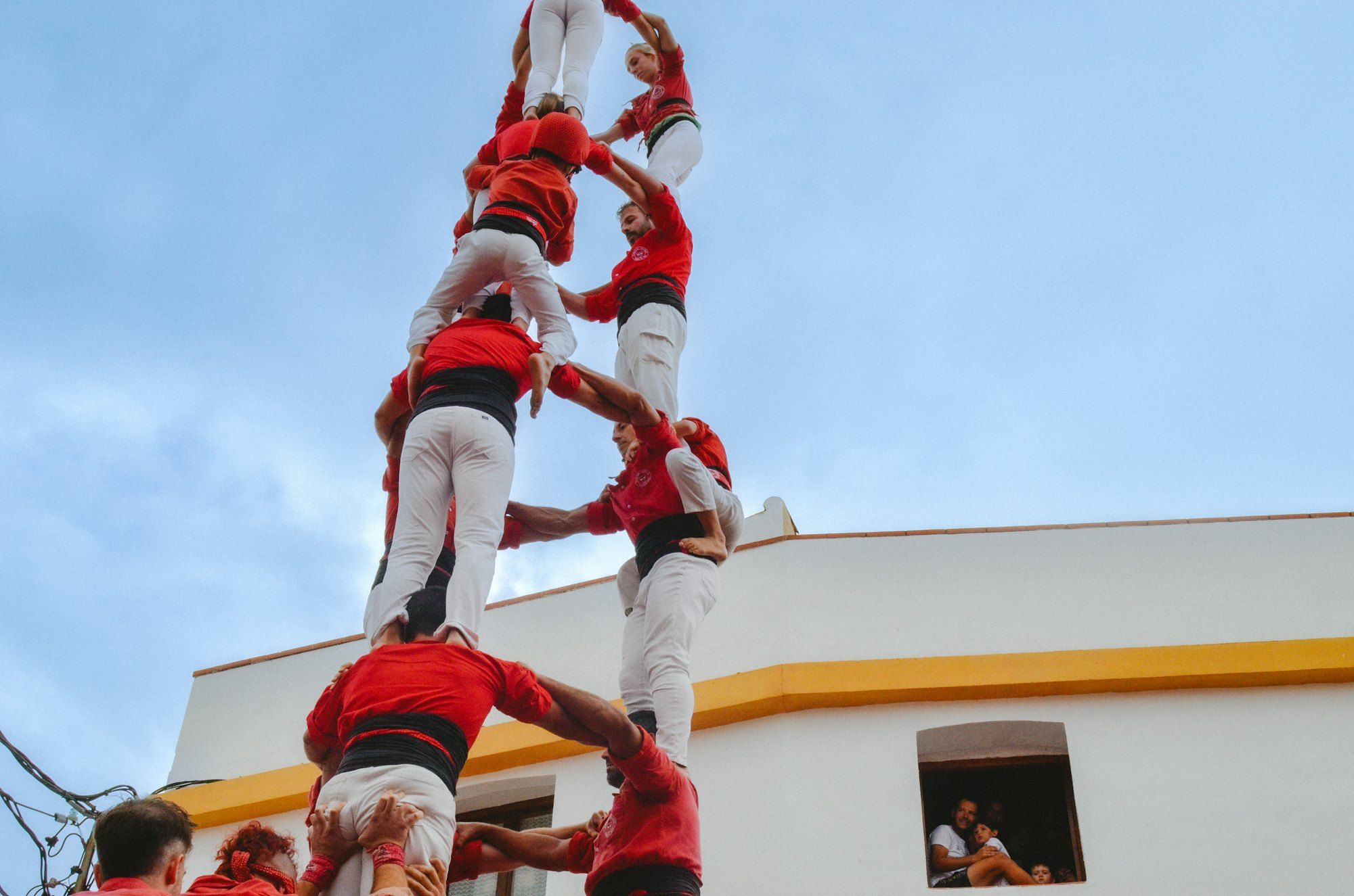 A human tower, each level supported by the one below